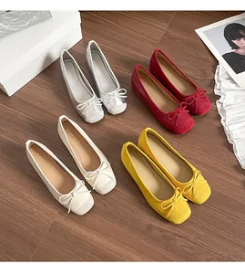 Macro view of multiple colors of French style ballet flats featuring delicate bow knots