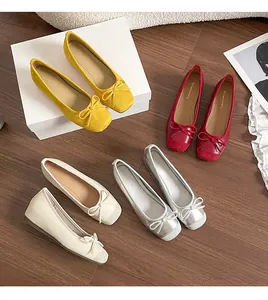 Detailed shot of French style ballet flats with bowknots in yellow, red, white, and silver