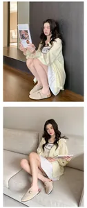 Asian model wearing beige suede buckle mule clogs in a comfortable indoor setting