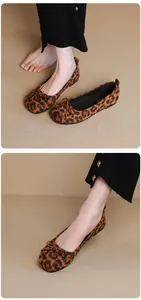 Detailed macro view showing the leopard print texture and bow of these ballet flats.