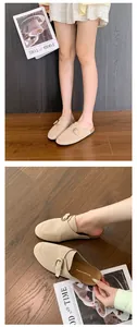 Detail view of beige suede platform mule slippers featuring an adjustable buckle strap