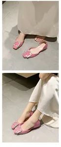 Close-up of elegant pink square toe shoes with sparkling rhinestone buckle detail