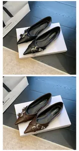 Detailed view of French-style pointed-toe flats with silver buckle straps in black and brown.