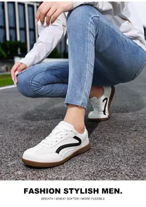 Detailed close-up of white German Army Trainer style sneakers with black accents