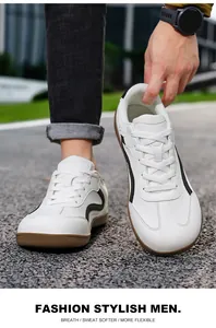 White leather German army style trainers with black stripes and gum sole