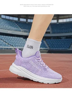 Detailed view of lightweight purple running shoe on foot at an athletic stadium track