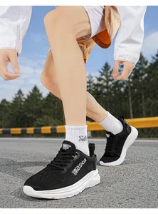 Dynamic action shot of lightweight black marathon running shoes for men on an outdoor track.
