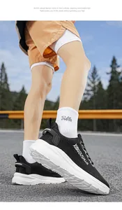 Close-up of lightweight black and white men's marathon running shoes on road