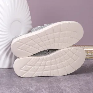 Macro view of the durable non-slip white rubber sole on grey canvas loafer shoes