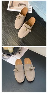 Stylish beige suede mules featuring adjustable vintage buckle strap for casual chic look.