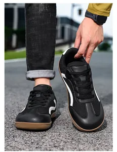 Detail shot of black leather GAT style men's sneakers with white stripes and gum sole.