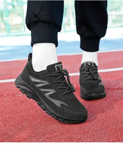 Detail view of black breathable men's walking sneakers with toggle laces on track