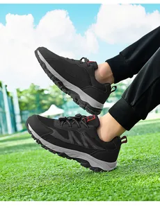 Men's breathable mesh sports walking shoes on outdoor grass field, comfortable sneakers