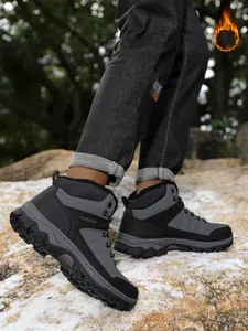 Detail view of men's warm hiking snow boots with fleece lining and rugged sole.