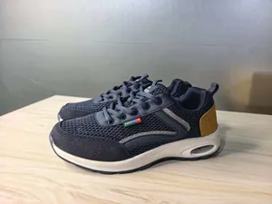 Detailed side view of breathable navy blue mesh sneakers with visible air cushion sole