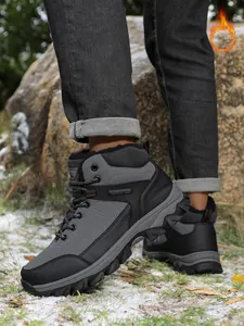 Detail view of grey men's winter hiking boots featuring warm fur lining and rugged sole.