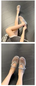 Detailed view of grey mesh Mary Jane shoes with rhinestones and buckle strap on model