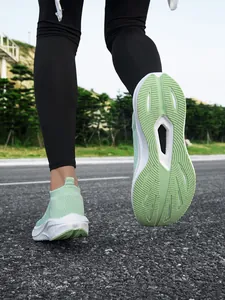 Detail view showing the textured green sole of a lightweight slip-on walking shoe