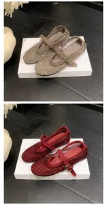Detailed view of rhinestone mesh Mary Jane flat shoes in red and champagne silver