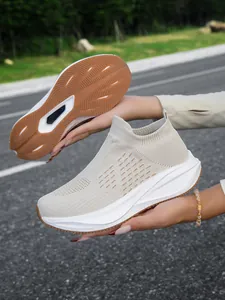 Detailed view of breathable beige slip-on walking shoes showing the anti-slip outsole