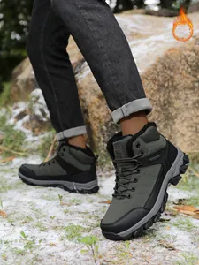 Outdoor lifestyle shot of warm fur-lined men's winter hiking boots on snowy ground.