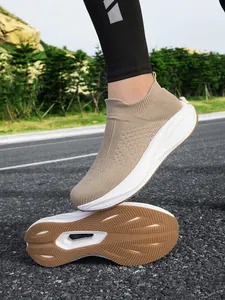 Detailed view of breathable khaki knit slip-on sneakers with anti-slip rubber sole