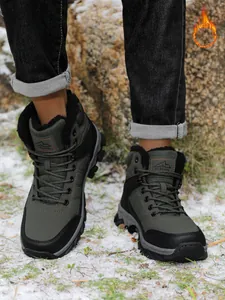 Detailed view of men's warm fur-lined snow boots for outdoor winter hiking