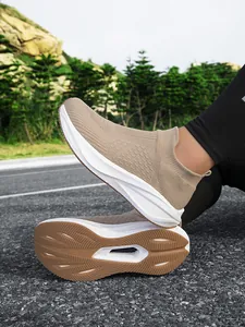 Detailed close-up view of the tan breathable knit slip-on walking shoe with durable sole