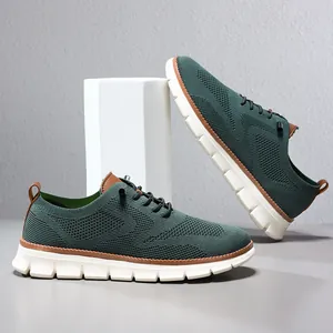 Detailed view of breathable dark green knitted men's sneakers with white soles.