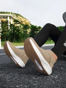 Detailed low angle shot of breathable khaki knit slip-on sneakers with durable non-slip soles.