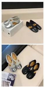 Close-up detail of vintage Tabi Mary Jane flat shoes in silver and black leather.
