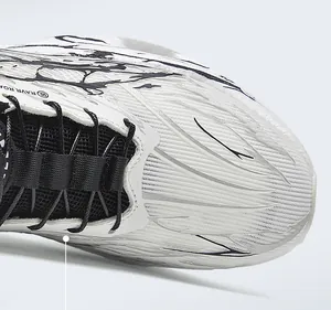 Detailed close-up showing the breathable mesh and ink-pattern design of white running shoes