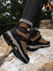 Outdoor view of men's winter hiking boots with warm faux-fur lining on snow