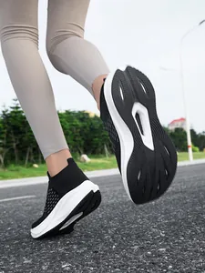 Dynamic detail of black slip-on walking shoes showing flexible sole on road