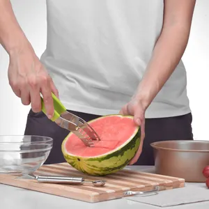Stainless steel watermelon slicer tool being used to cut fresh fruit into pieces