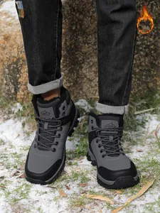Professional outdoor hiking boots for men with warm fleece lining in a snowy landscape
