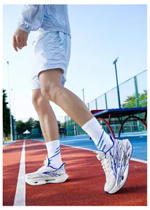 Detail of breathable white and blue men's running shoes with rotary buckle and hollowed sole