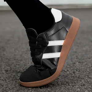 Flexible black leather sneakers with white stripes and a classic brown gum sole for men