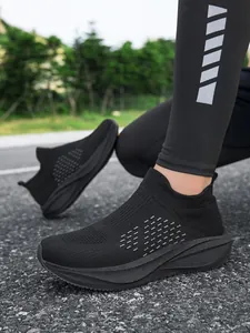 Breathable lightweight black knit slip-on sneakers for comfortable outdoor walking style.