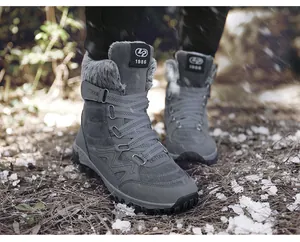 Close-up of grey winter snow boots with warm faux fur lining in an outdoor setting