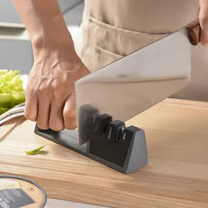 Two-stage manual knife sharpener for quick kitchen blade sharpening on a wood board