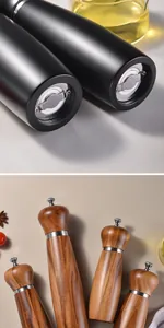 Close-up detail of adjustable acacia wood and matte black manual pepper grinders.
