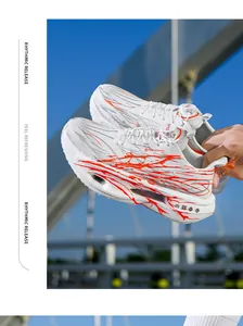 Detailed view of white mesh running shoes with orange spray patterns and rotary buckle