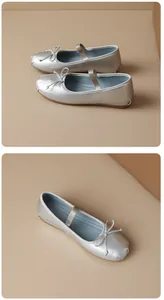Detail view of elegant silver Mary Jane ballet flats featuring bow and elastic strap