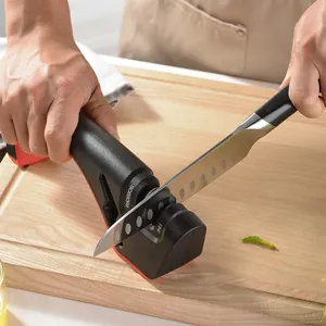 Professional three-stage manual knife sharpener shown in use on a wooden cutting board