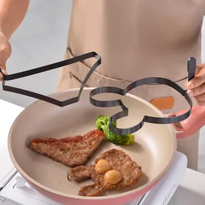 Non-stick stainless steel pancake and egg molds with heat-resistant handles shown in use