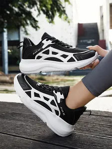 Detail view of men's breathable black and white mesh running sneakers on feet