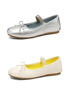 Detail view of silver and cream ballet flat Mary Jane shoes with bow decoration