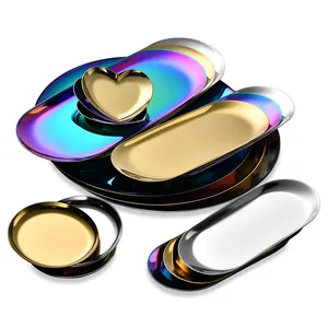 Stack of colorful stainless steel serving trays in oval, round, and heart shapes