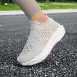 Lightweight beige knit slip-on sneakers with chunky white platform soles for walking